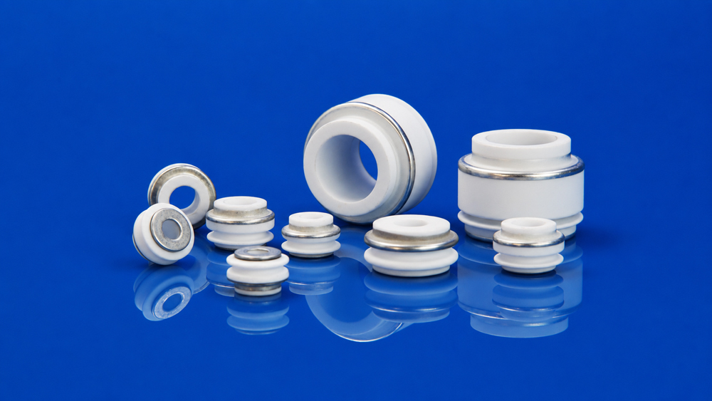 Metallized ceramic bushing product for vacuum and high-voltage assemblies